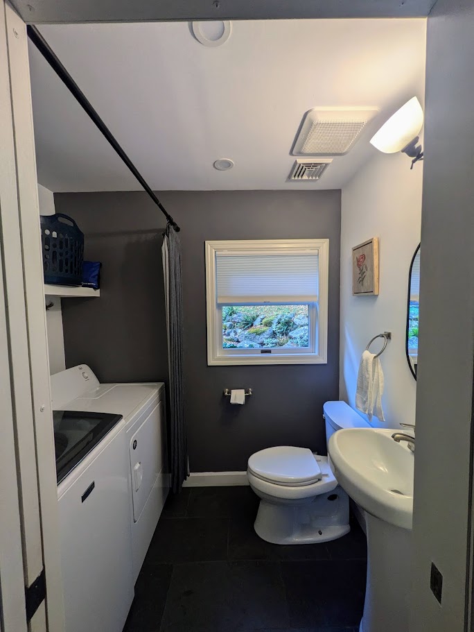 Downstairs bathroom with washer and dryer